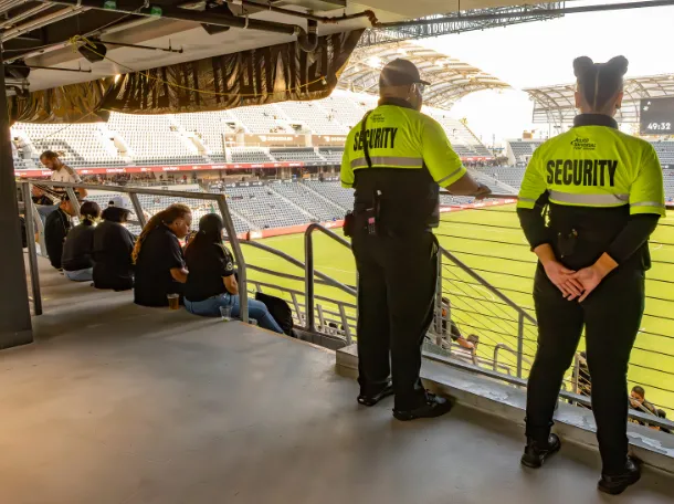 2 guards in uniform looking at the ground