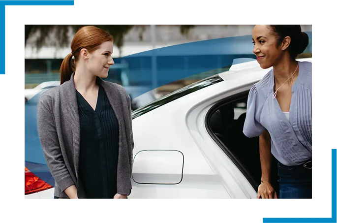 Two ladies smiling at each other